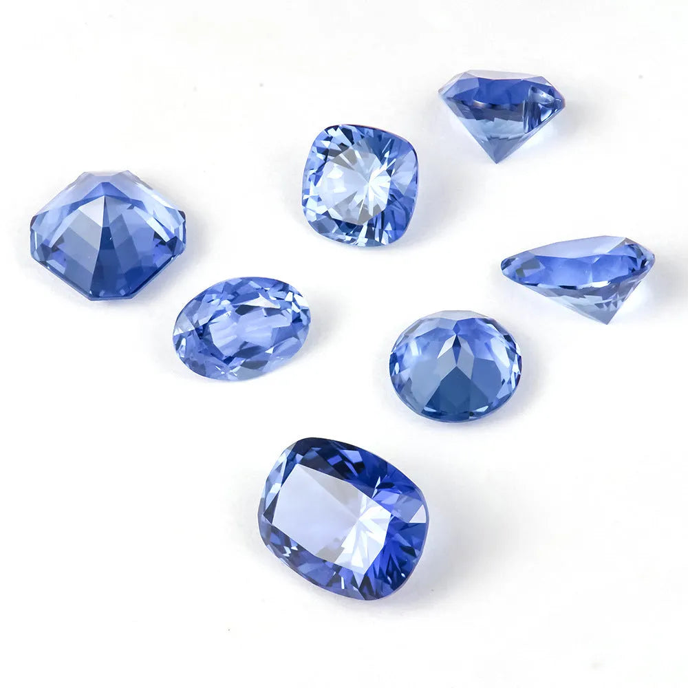 Royal blue love-shaped tiara cultivation gemstone in heart, round, and pear shapes on a jeweller's cloth.