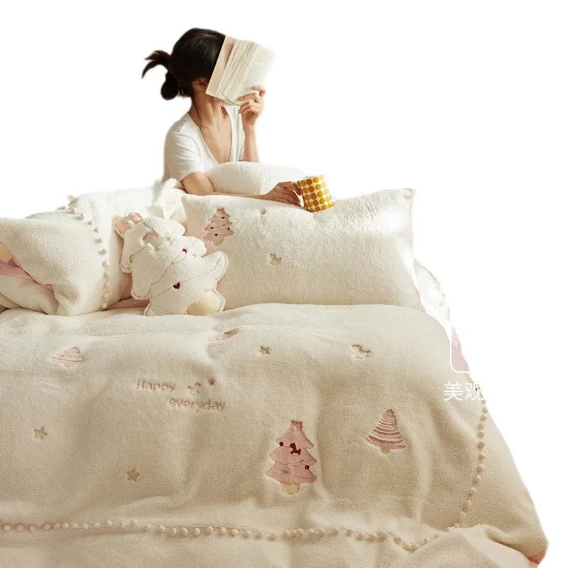 Winter milk fibre four-piece bedding set with green or pink Christmas tree pattern on a bed