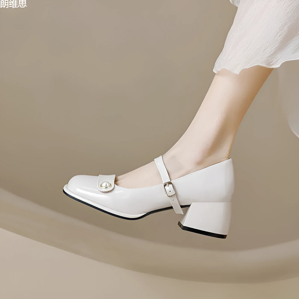 Women's patent leather chunky heel pumps with square toe and buckle fastening, shown in apricot colour.