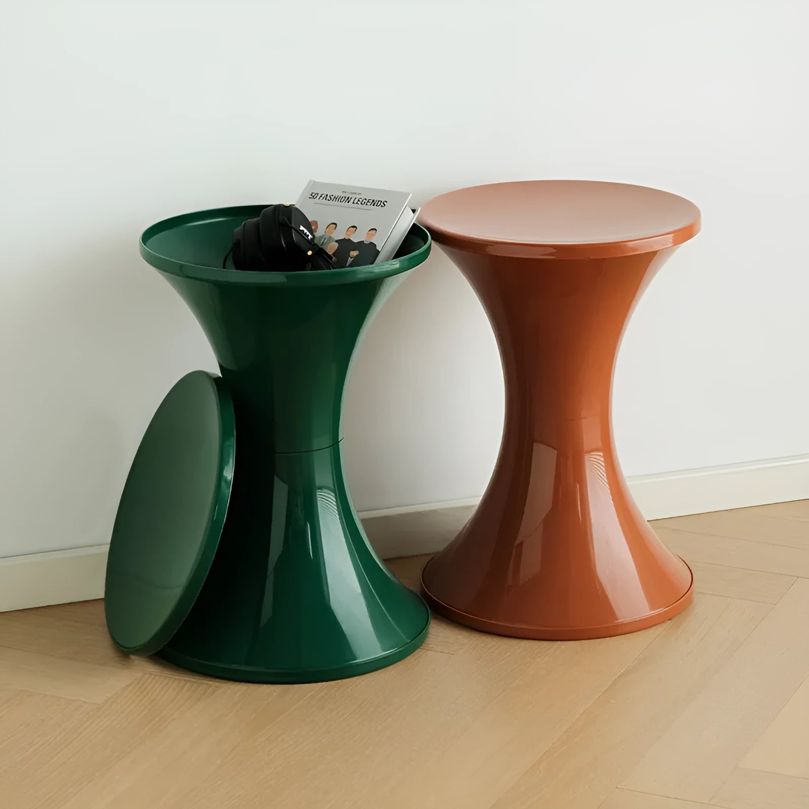 A plastic hourglass-style shoe changing stool in one of five available colours: black, green, red, white, or brown.
