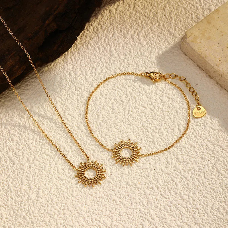Gold sunflower bracelet and necklace set with geometric chain design