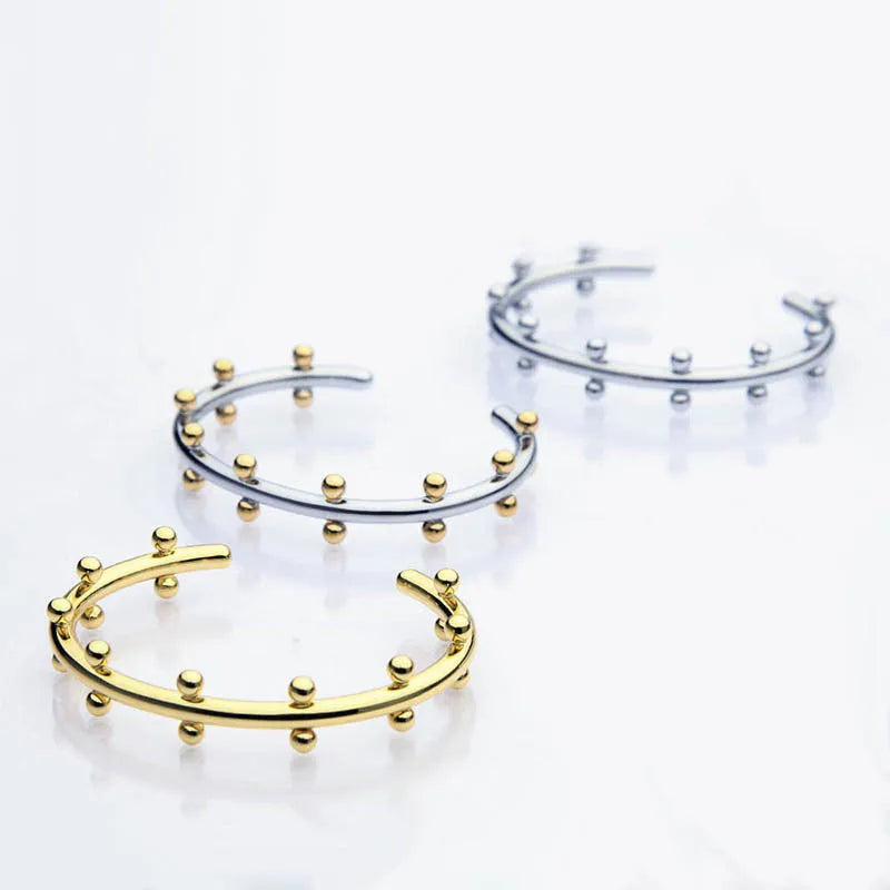 Stainless steel C-shaped beads with rivet texture in gold, steel, and steel gold colours for jewellery making.
