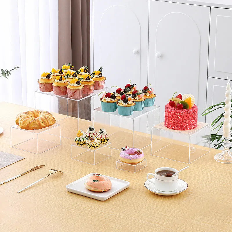 White plastic suit cube dessert display stand with six individual cubes for wedding cakes and pastries.