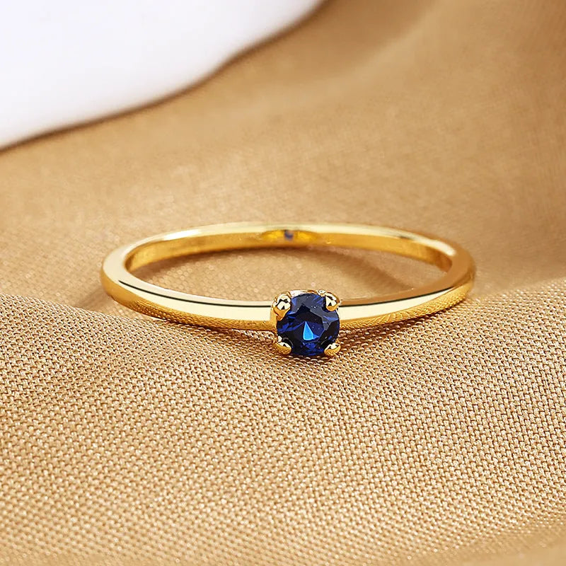 Women's geometric copper circle ring with single diamond in white, red, green, or blue colours