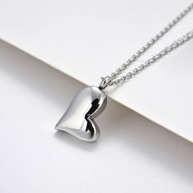 Silver tone curved peach heart stainless steel pendant necklace with adjustable chain