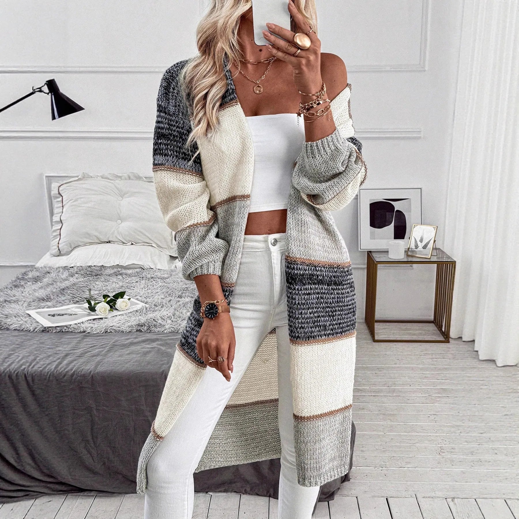 Women's grey knitted long cardigan with loose fit and stripe plaid pattern on hanger