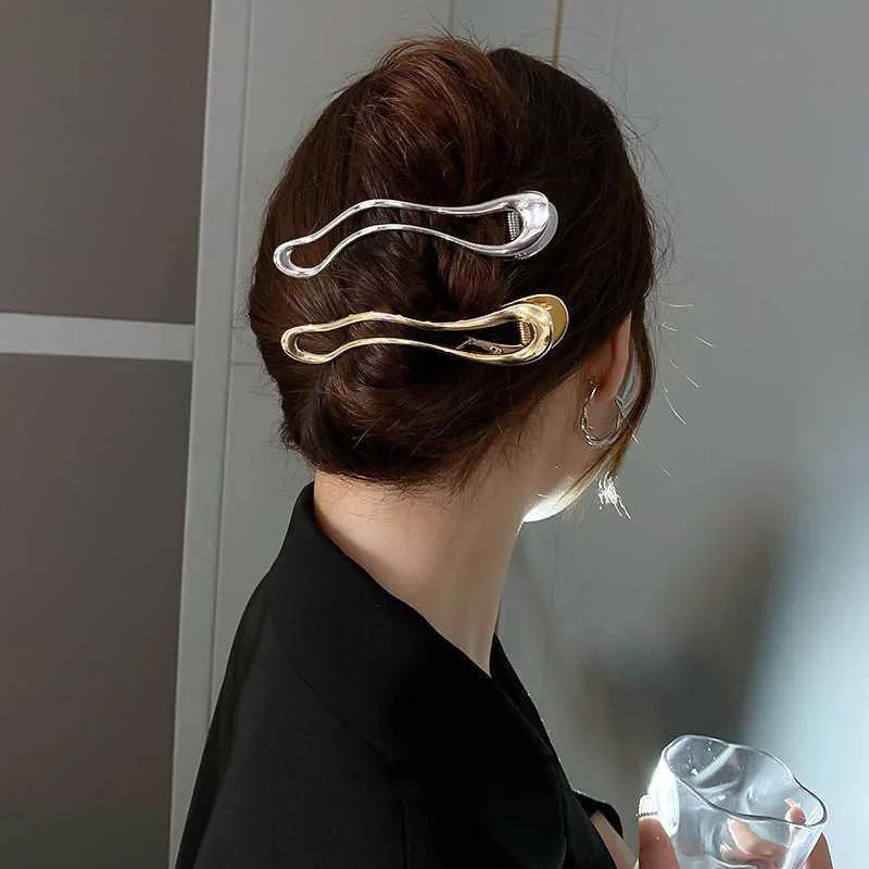 Women's zinc alloy hair barrette in gold and silver, showing square, arc and triangle shapes.