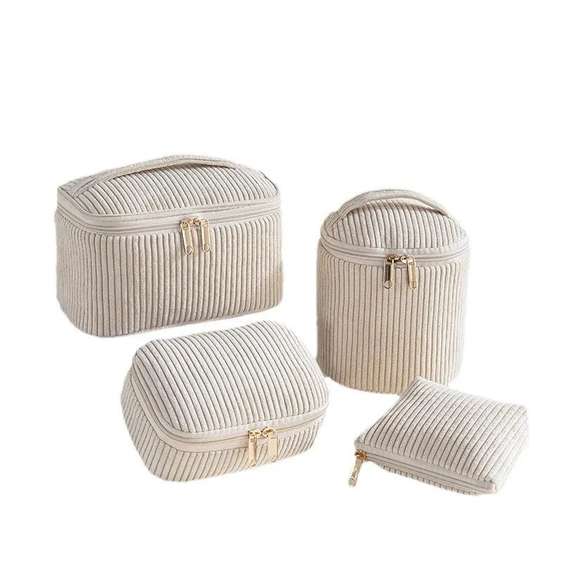 Four cube-style flannelette makeup bags in matching colour set on white background