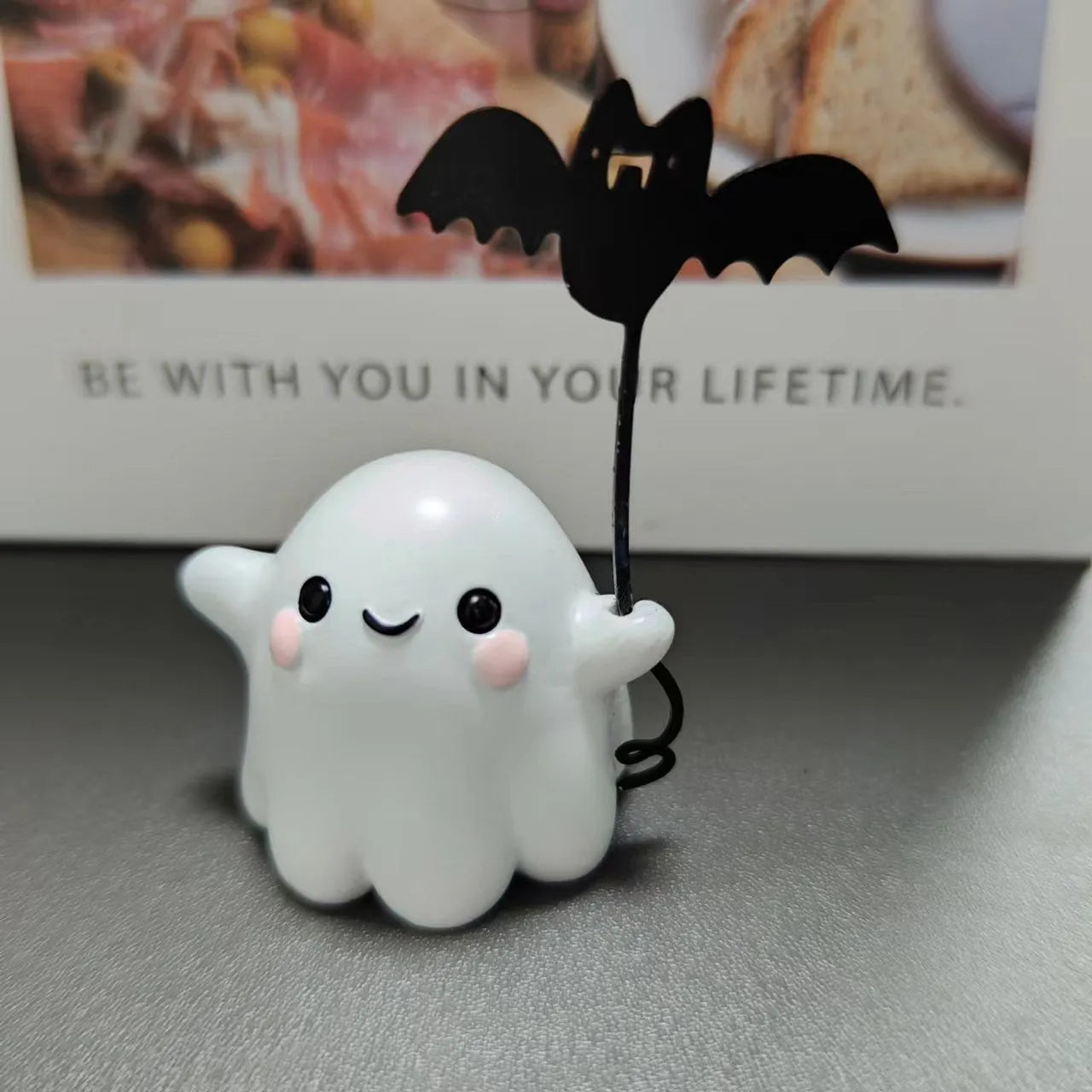 Mini resin figurine of a ghost walking a small dog, a 4x5x4cm Halloween decoration.