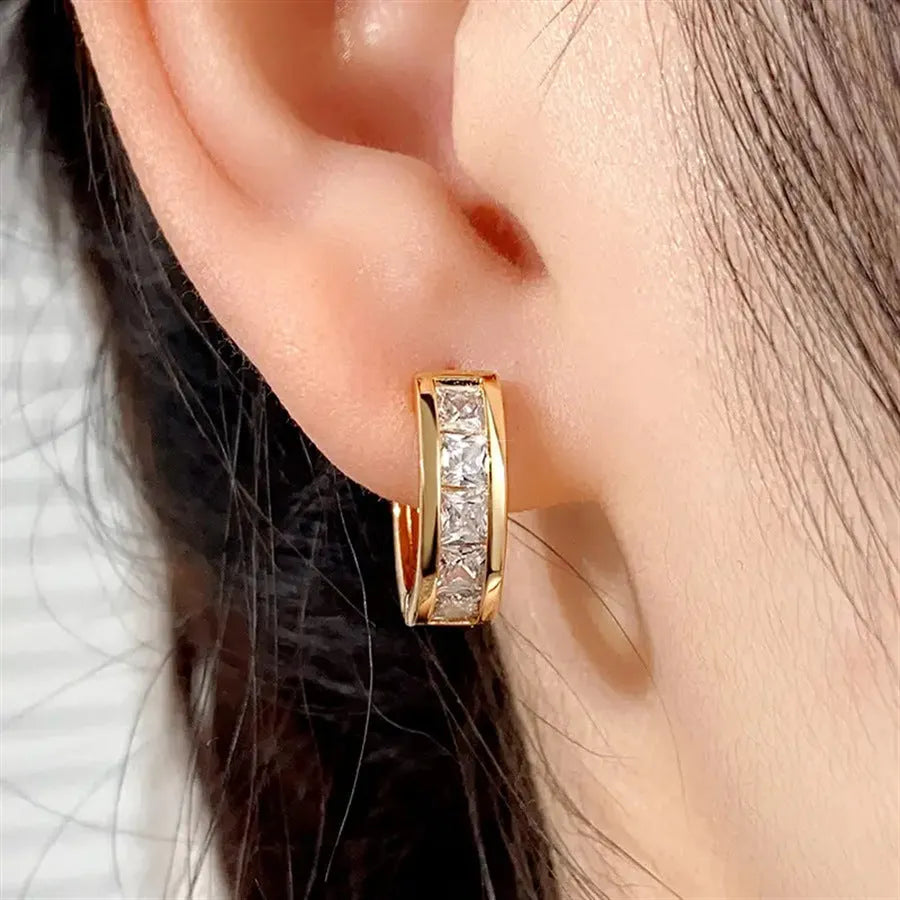 Women's geometric quadrilateral copper drop earrings in gold and silver colour options.