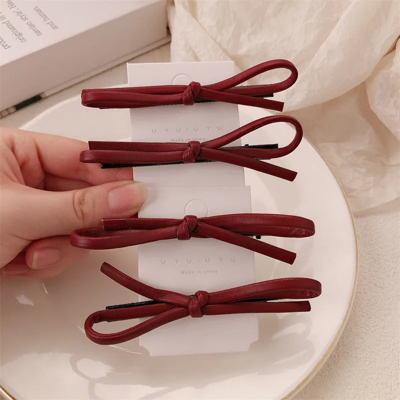 Wine red leather bow barrette hair clip with adjustable metal grip mechanism
