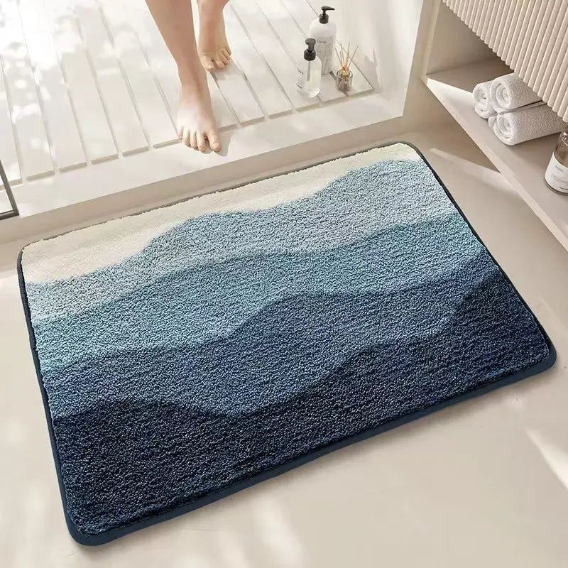 Square polyester fibre floor mat with rainbow pattern in sky sea colours and plastic bottom backing
