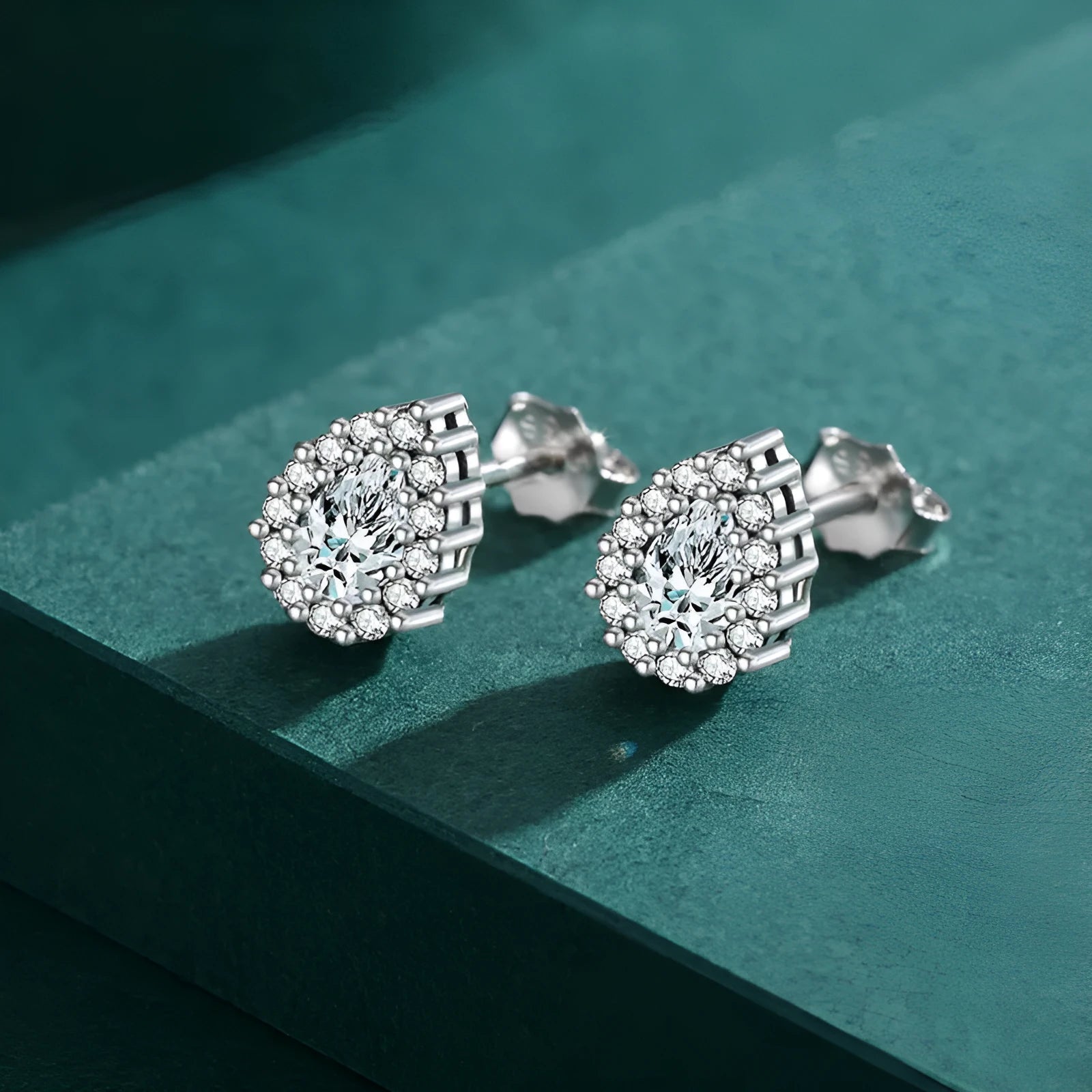 Women's silver water drop stud earrings crafted from 925 sterling silver with diamond treatment