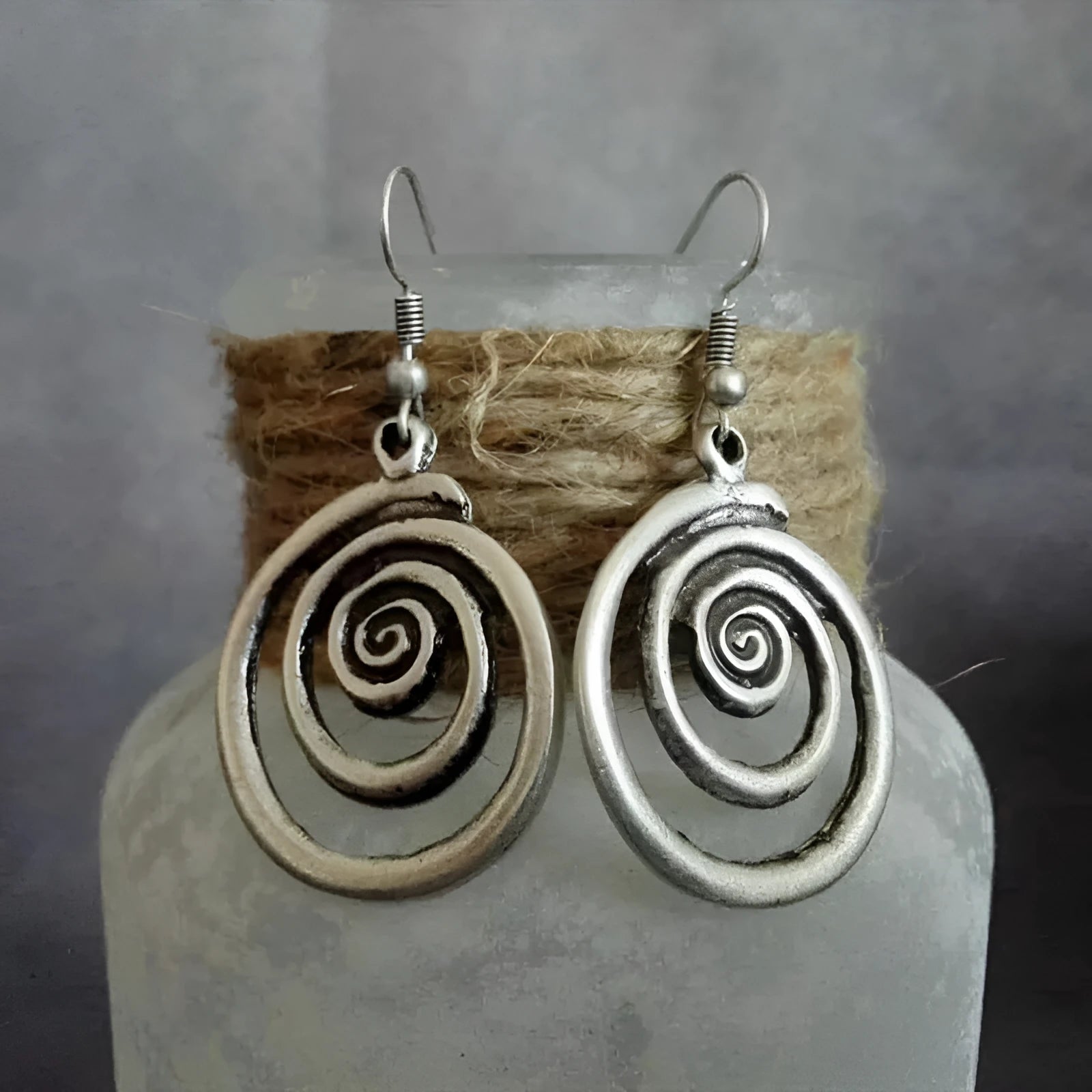 Silver geometric spiral earrings with distressed texture, measuring 2.6cm by 5cm
