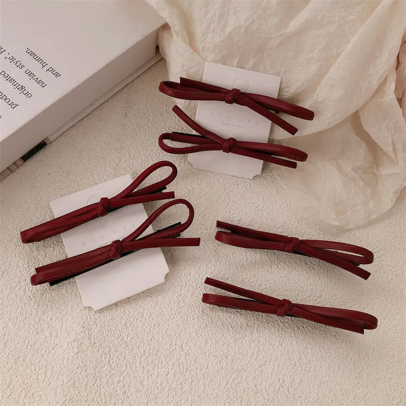 Wine red leather bow barrette hair clip with adjustable metal grip mechanism
