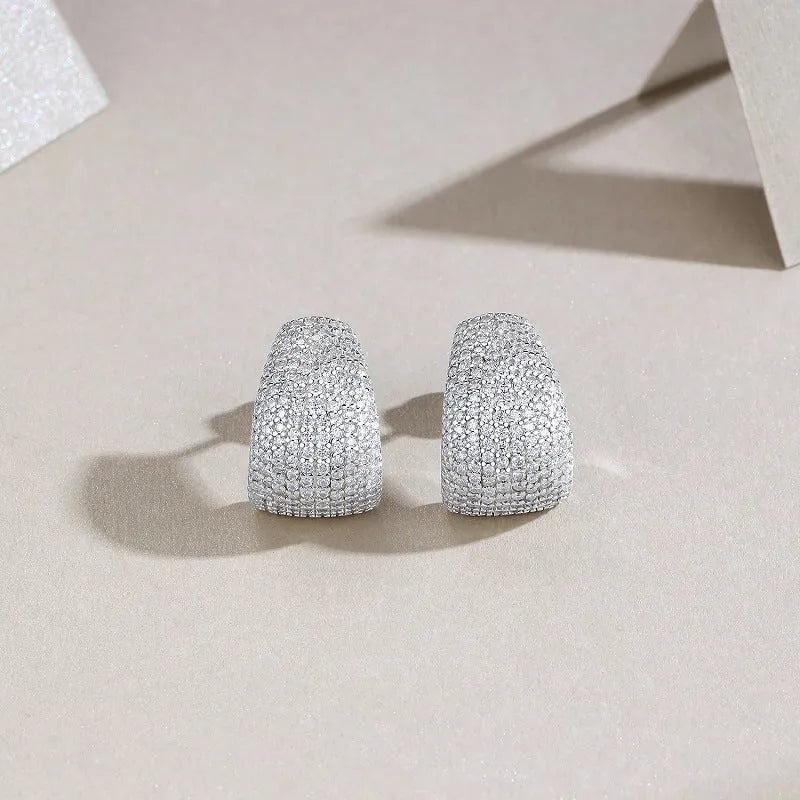 Geometric shaped S925 sterling silver ear studs with moissanite stones, shown with alloy backs.
