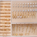 108 geometric alloy earrings in gold and yellow colours with round pearl-like elements