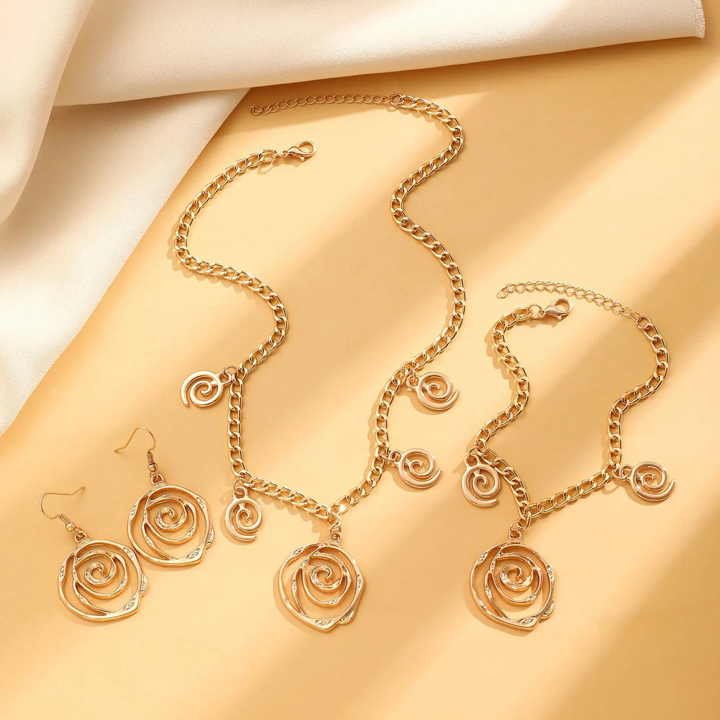 Spiral donut jewellery set with necklace, bracelet and ear hooks in gold or silver tone