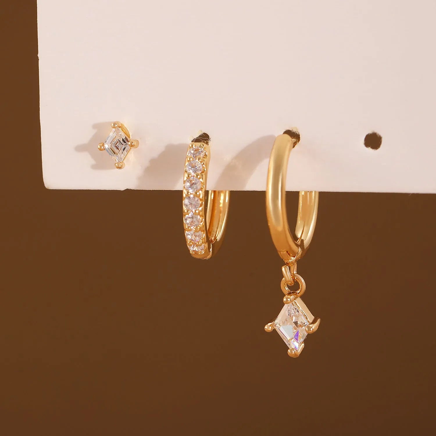 Ladies geometric jewellery set with zircon stones including pendant, ear clips, and stud earrings in gold or white