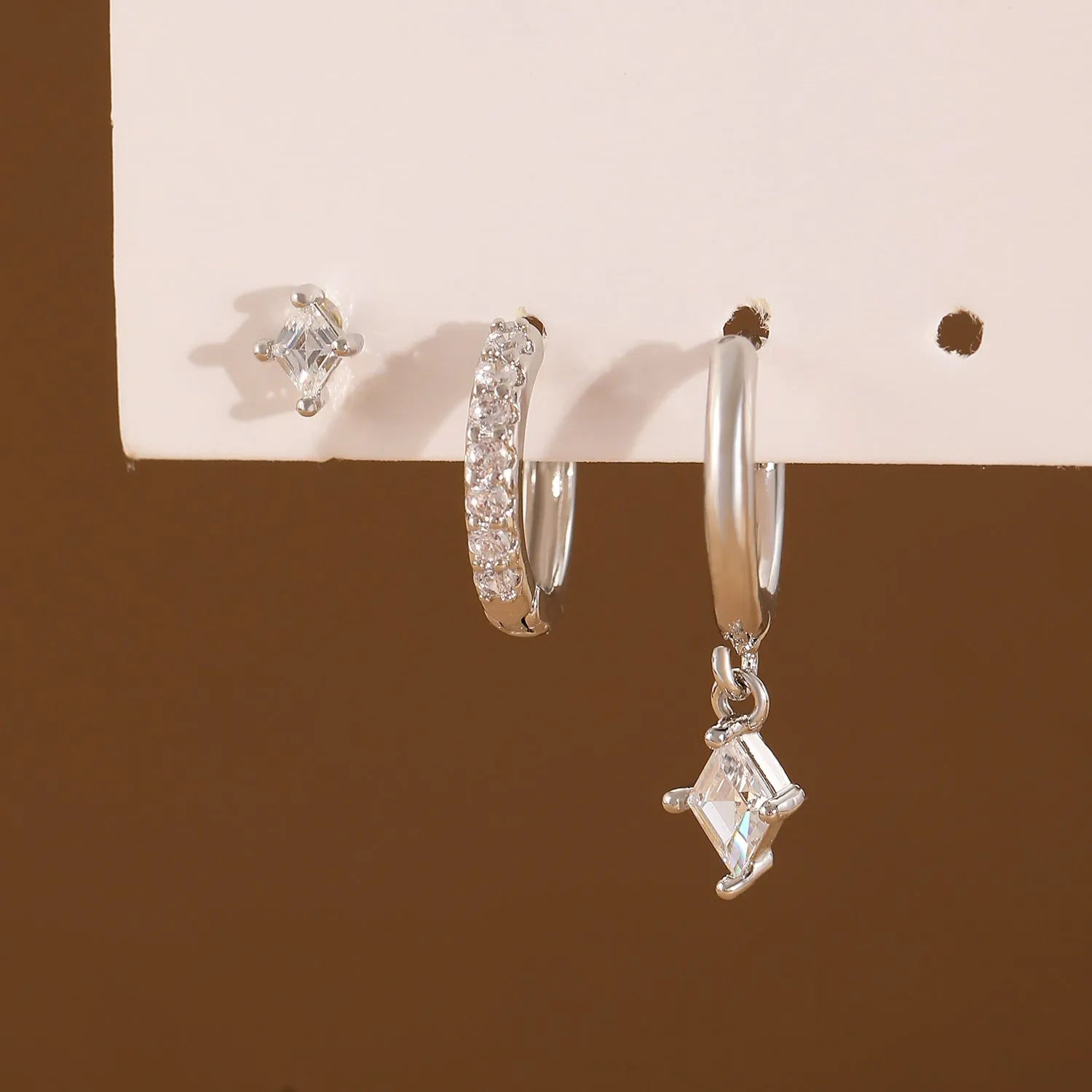 Ladies geometric jewellery set with zircon stones including pendant, ear clips, and stud earrings in gold or white