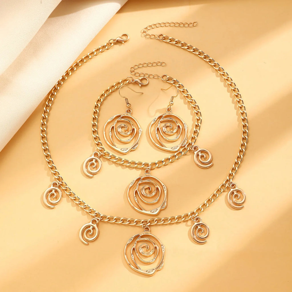 Spiral donut jewellery set with necklace, bracelet and ear hooks in gold or silver tone