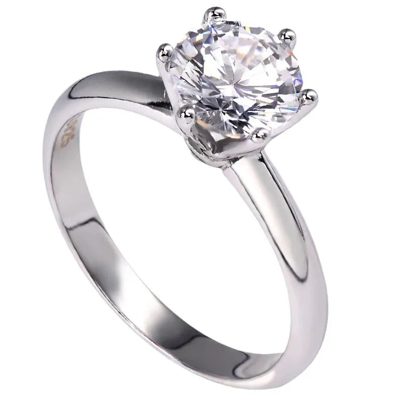 White gold plated zircon ring with six-claw setting and geometric design shown on finger