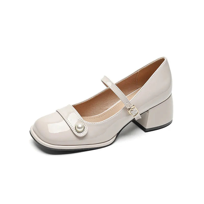 Women's patent leather chunky heel pumps with square toe and buckle fastening, shown in apricot colour.