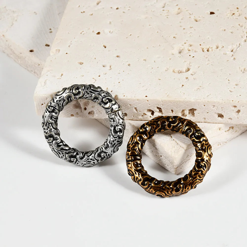 A pair of stainless steel fashion earrings featuring a detailed totem pattern, shown in one of fifteen available colour finishes.