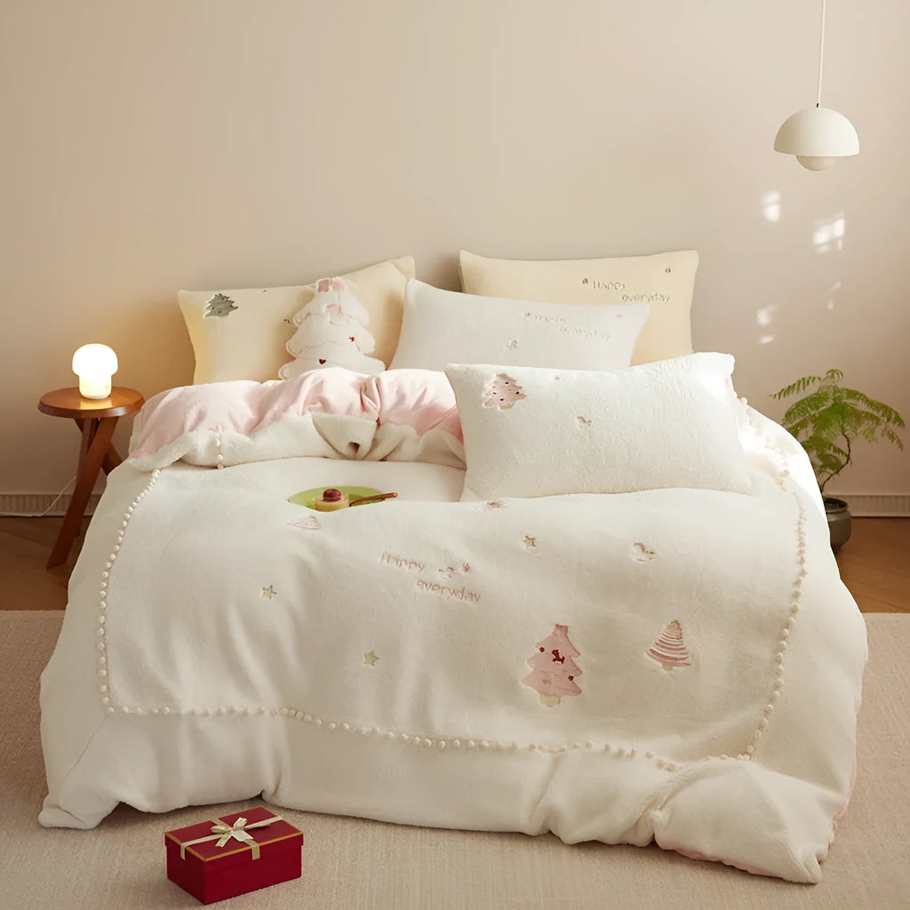 Winter milk fibre four-piece bedding set with green or pink Christmas tree pattern on a bed