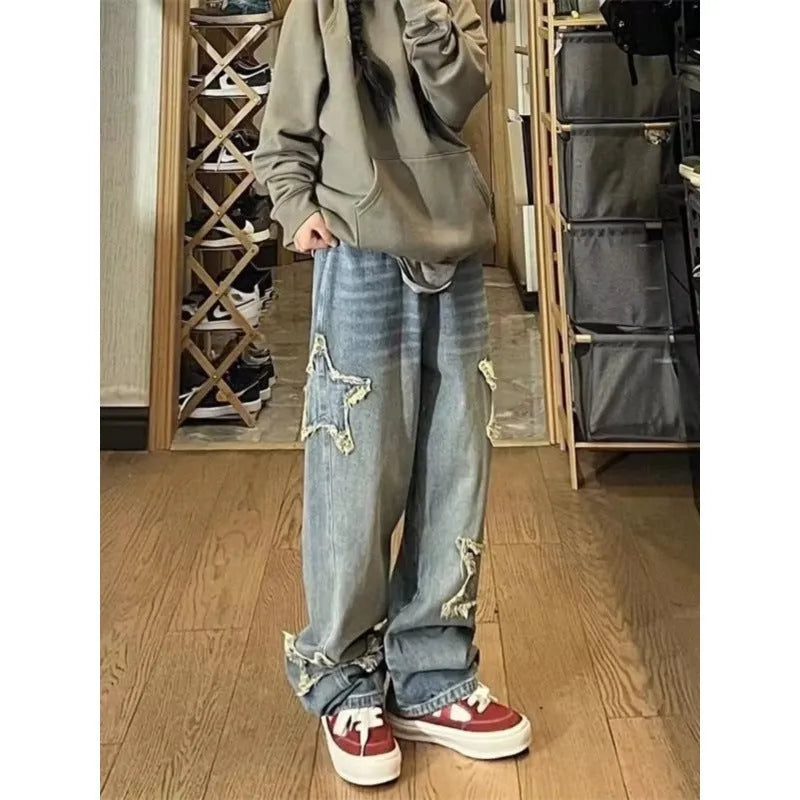 Blue women's high-waisted straight-leg jeans laid flat, showing the front design and medium wash denim texture.