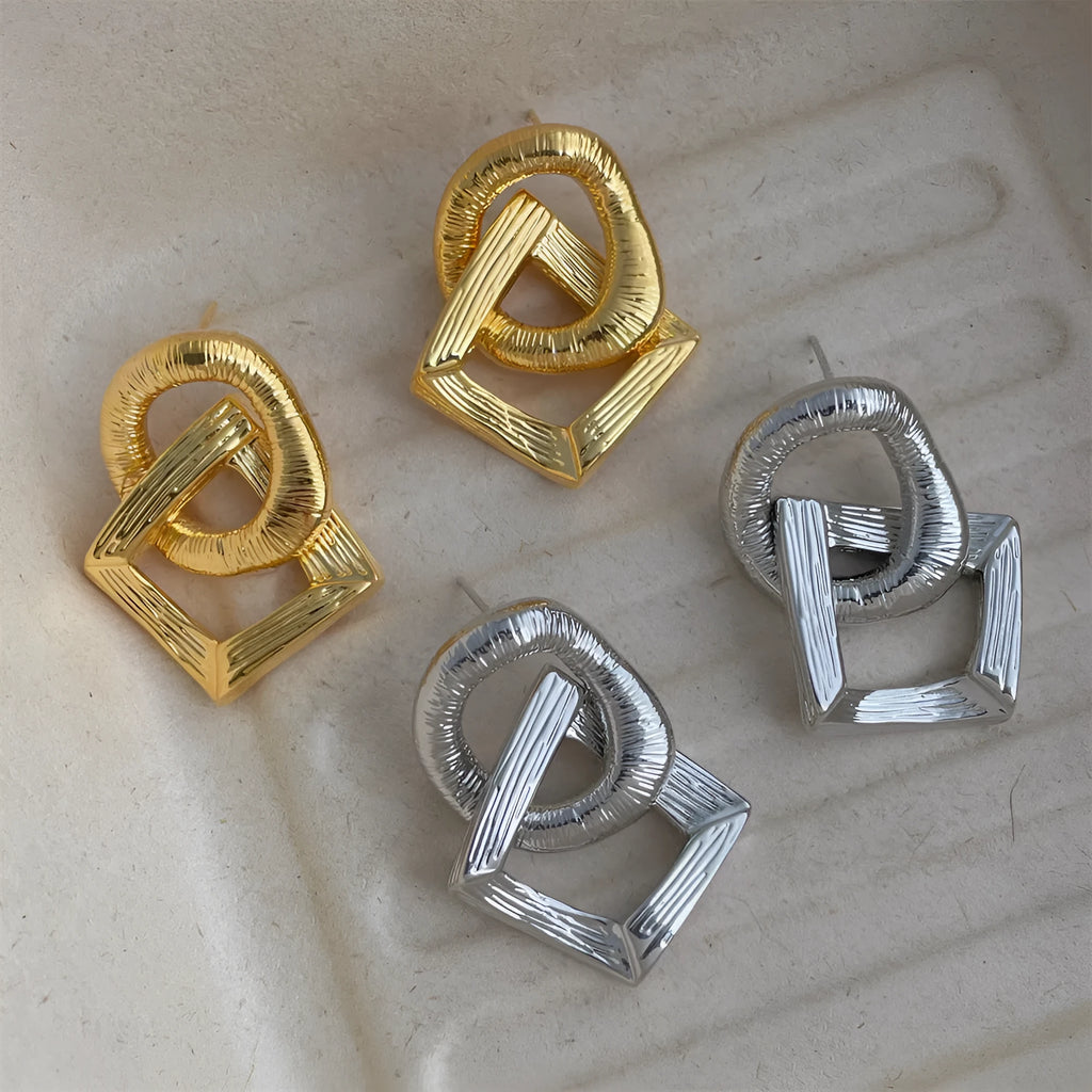 Retro style geometric circle pendant earrings in gold or silver colour with a 3.4cm drop length.
