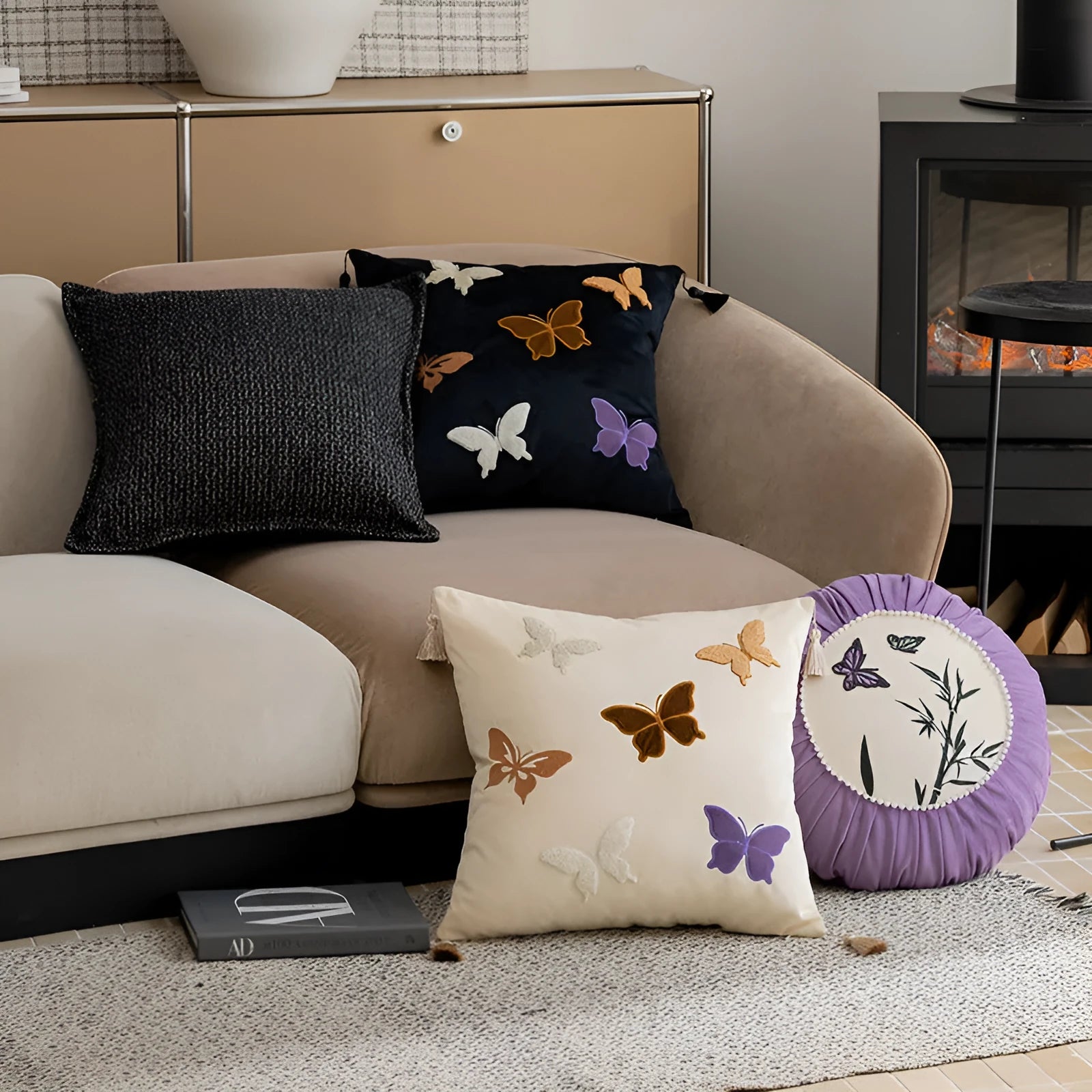 Square beige couch pillow with detailed Chinese-style butterfly embroidery.