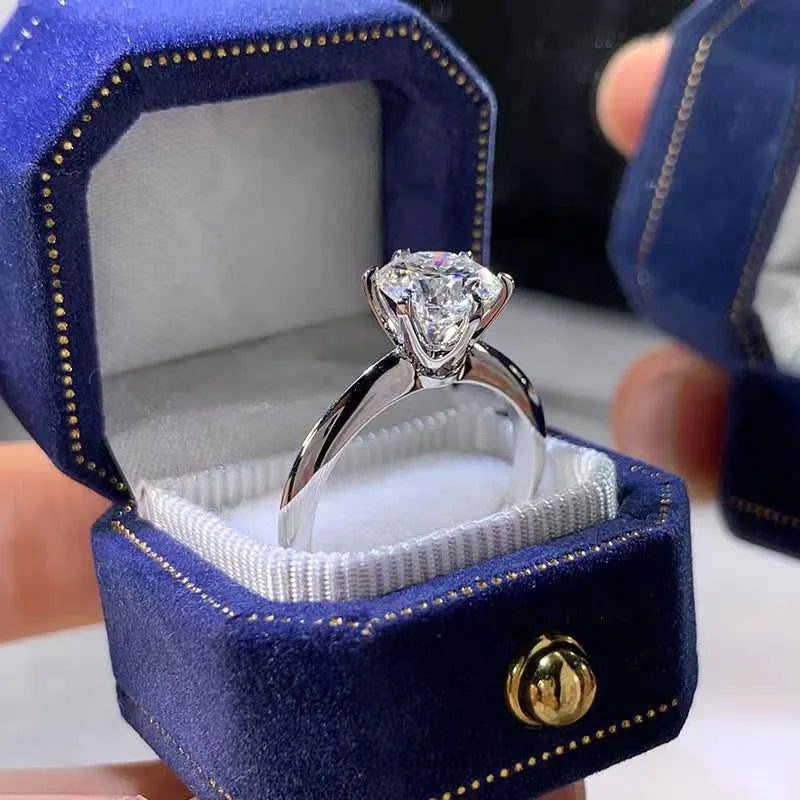 White gold plated zircon ring with six-claw setting and geometric design shown on finger