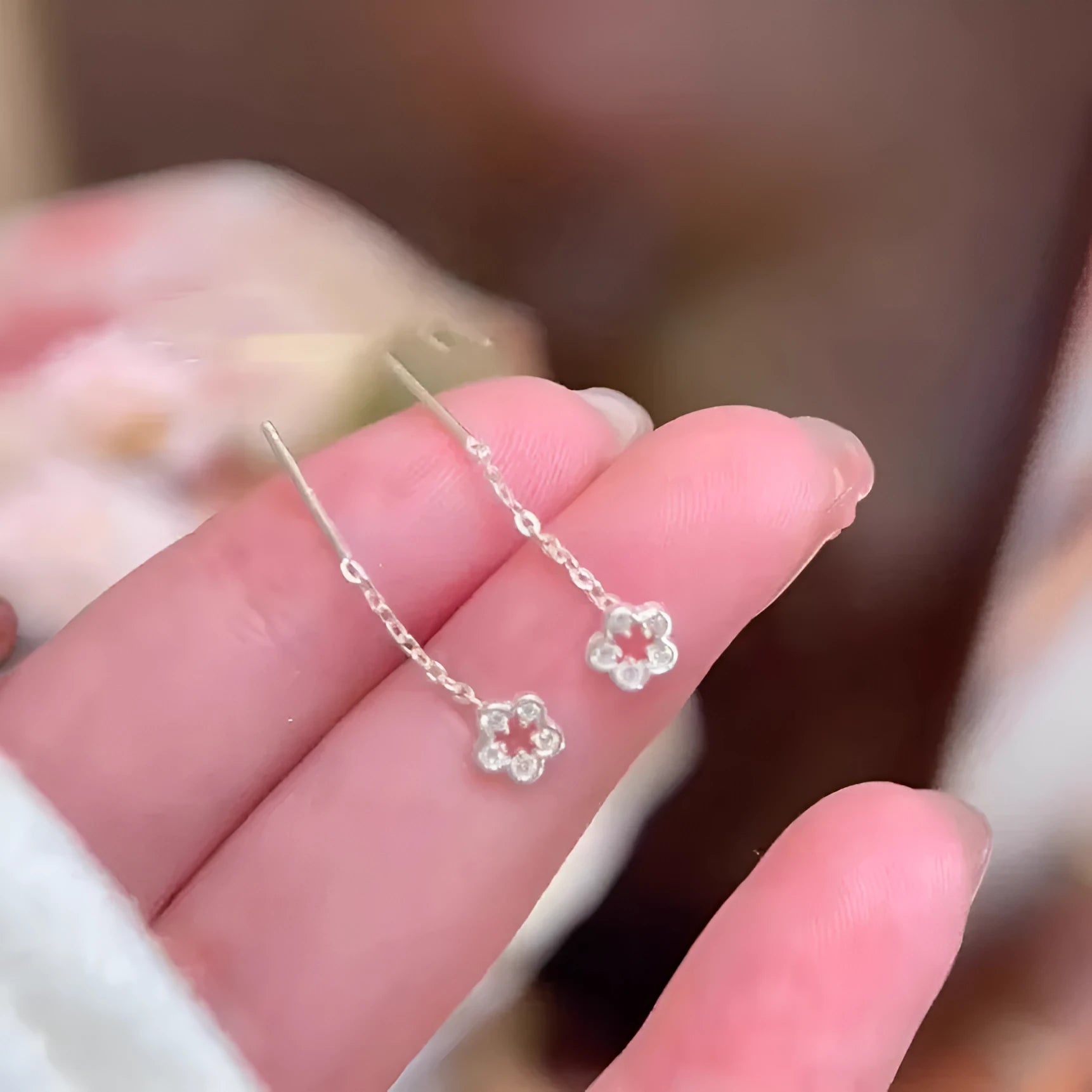 Sterling silver colour hollow flower hanging earrings with petal design
