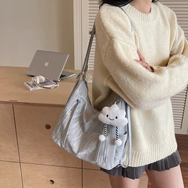 Women's fashion backpack in soft PU leather, shown in black, milky white, silver, and blue colour options with a pendant.