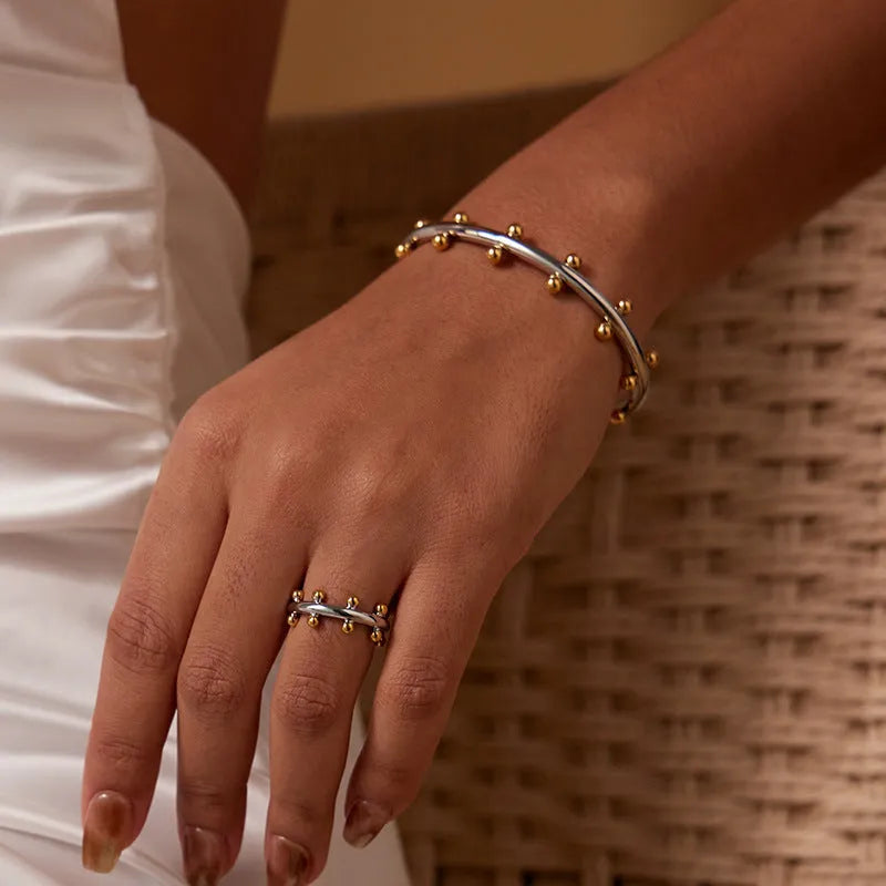 Stainless steel C-shaped beads with rivet texture in gold, steel, and steel gold colours for jewellery making.