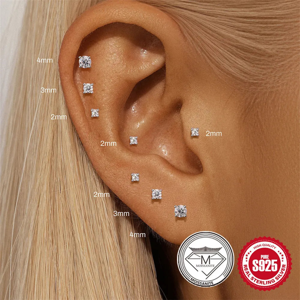 S925 sterling silver stud earrings showing petal, geometric, and round diamond designs on a grey background.