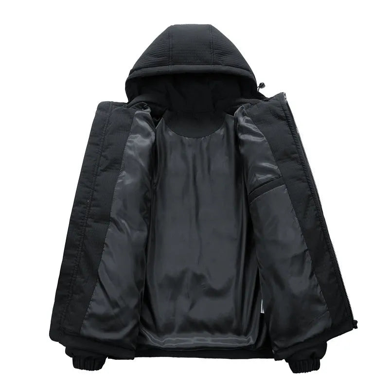 Man wearing a black hooded padded coat with a chest letter print and side pockets.