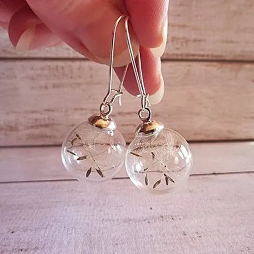 Transparent glass ball earrings with dandelion seed design inside, shown with French hooks