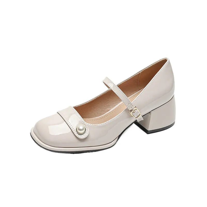 Women's patent leather chunky heel pumps with square toe and buckle fastening, shown in apricot colour.