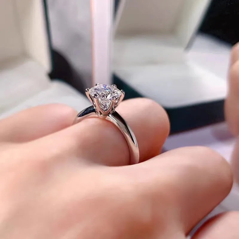 White gold plated zircon ring with six-claw setting and geometric design shown on finger