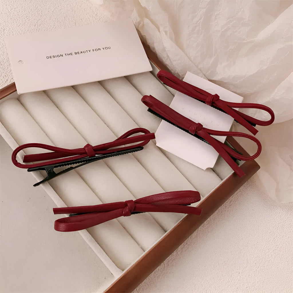 Wine red leather bow barrette hair clip with adjustable metal grip mechanism