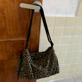 Leopard print sports style cross-body messenger bag with large capacity and cloth construction