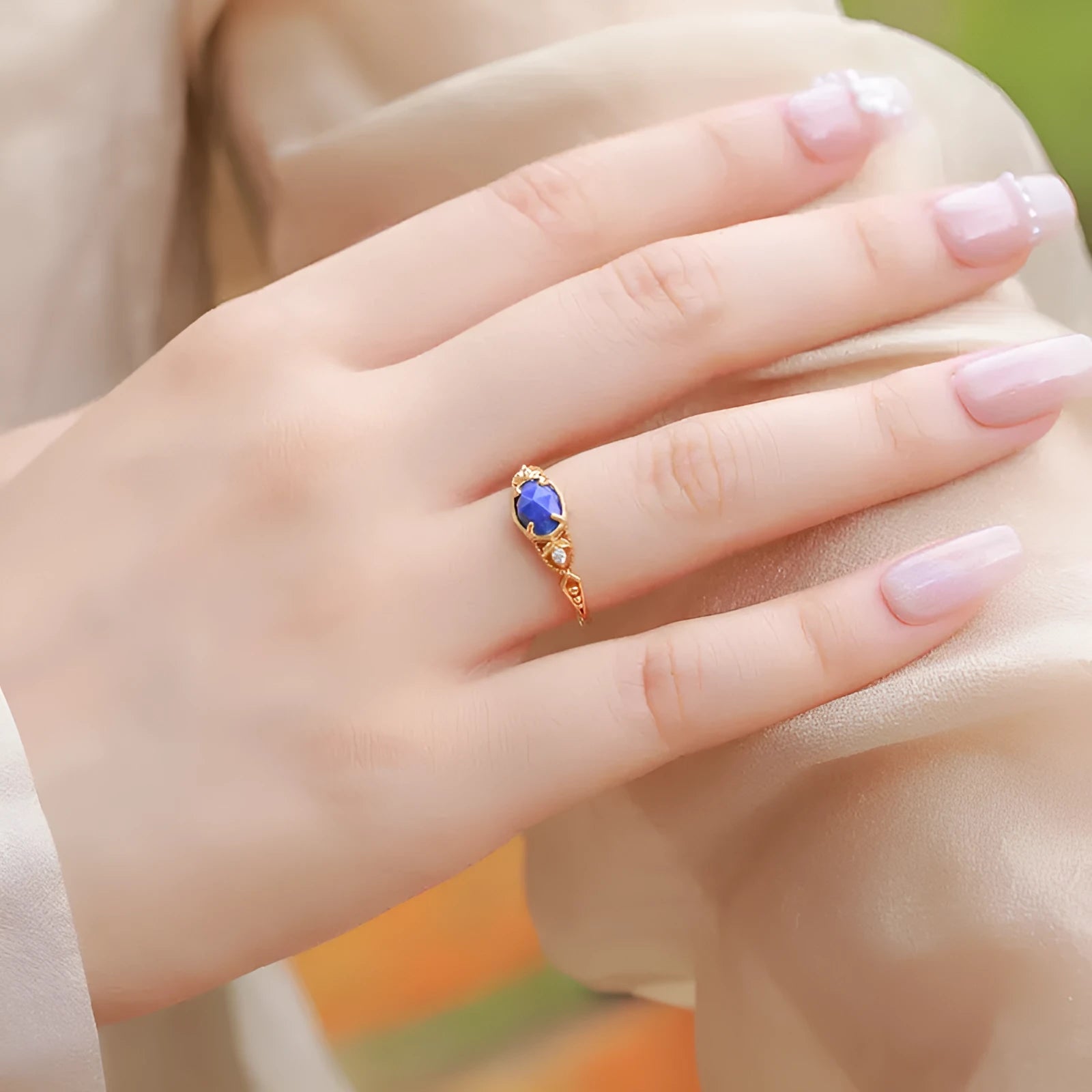 Japanese style geometric ellipse silver alloy ring for women in a lapis lazuli forest night sky colour.