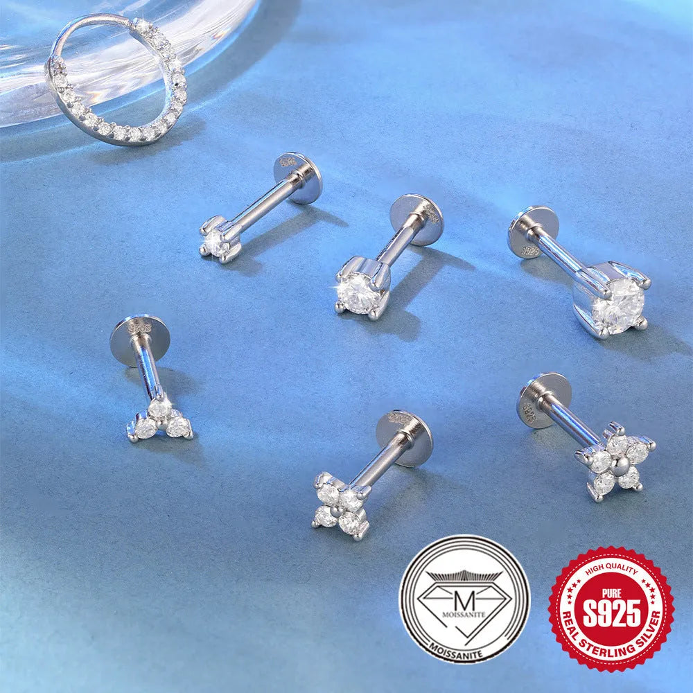 S925 sterling silver stud earrings showing petal, geometric, and round diamond designs on a grey background.