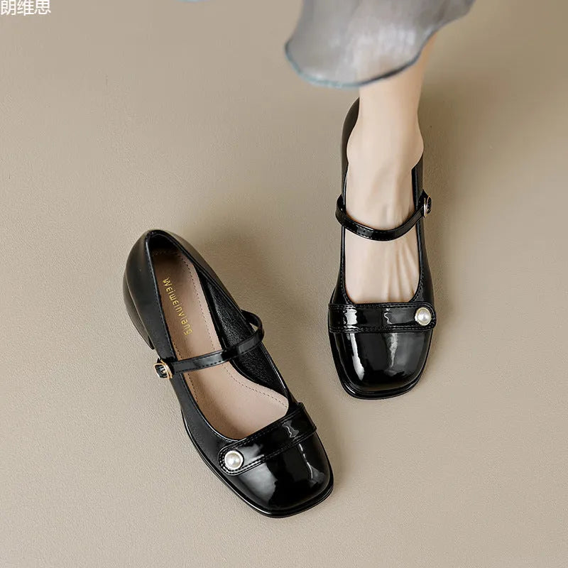 Women's patent leather chunky heel pumps with square toe and buckle fastening, shown in apricot colour.