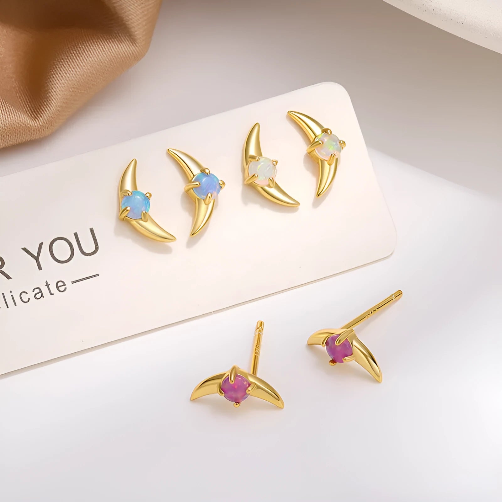Geometric 925 silver earrings with electroplated gold or platinum finish and coloured stone.