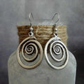 Silver geometric spiral earrings with distressed texture, measuring 2.6cm by 5cm
