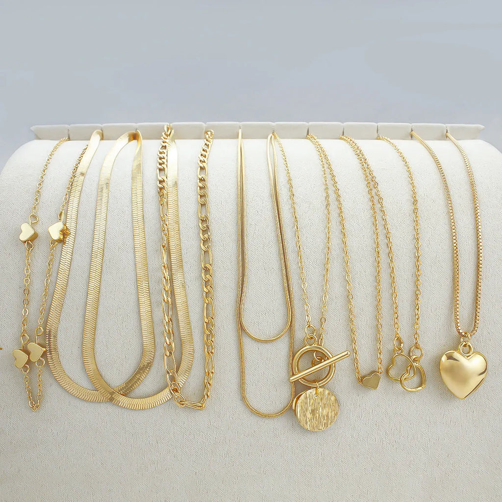 Set of 10 gold electroplated women's necklaces with snake bones chains and alloy pendants