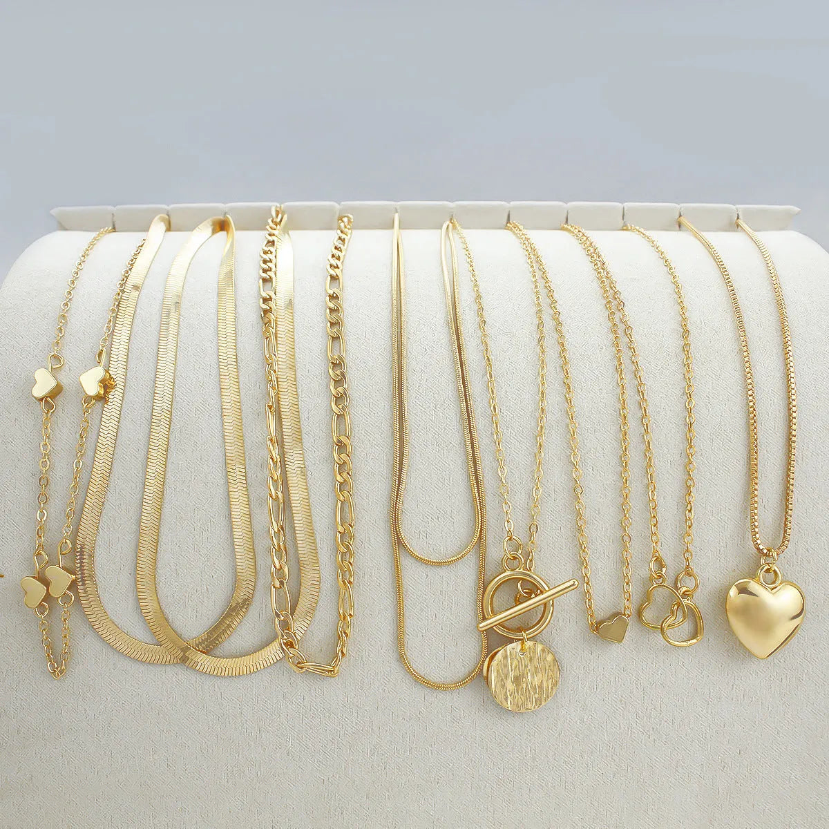 Set of 10 gold electroplated women's necklaces with snake bones chains and alloy pendants